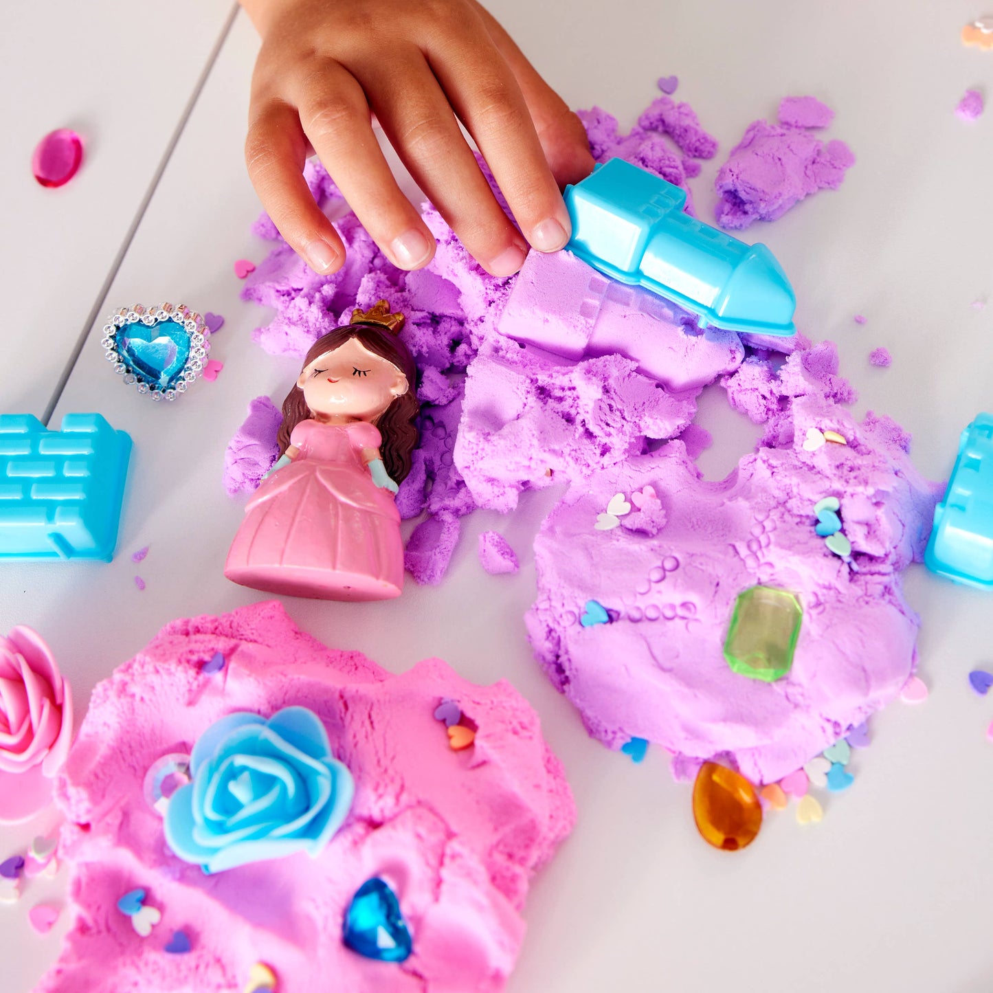 Sensory bag contains, magic wand, gems, flowers, heart confetti, princess, ring, and cloud clay