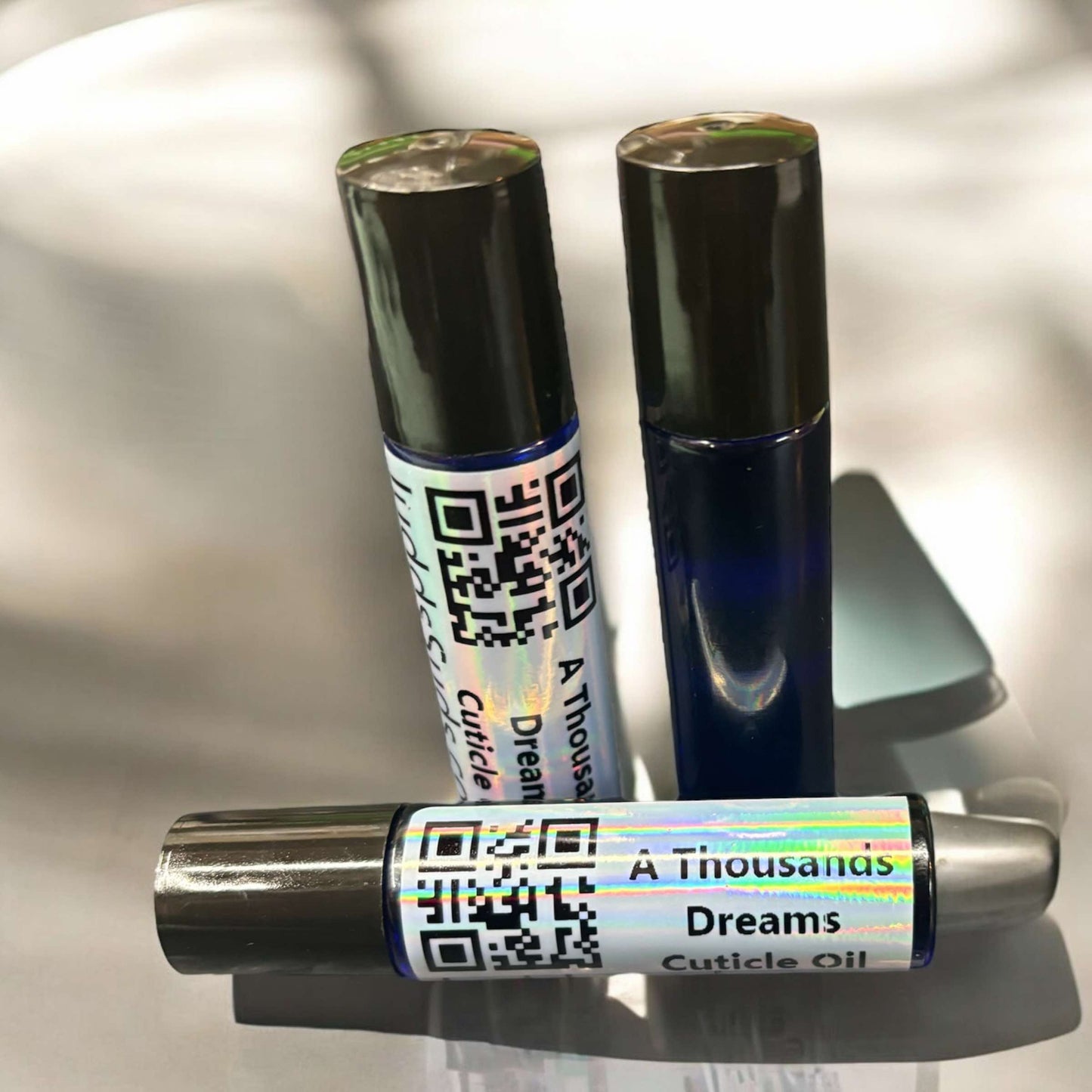 1.25 glass roller bottle, contains almond, avocado, castor oil, and vitamin E oil. Scented with A Thousand Dreams fragrance oil