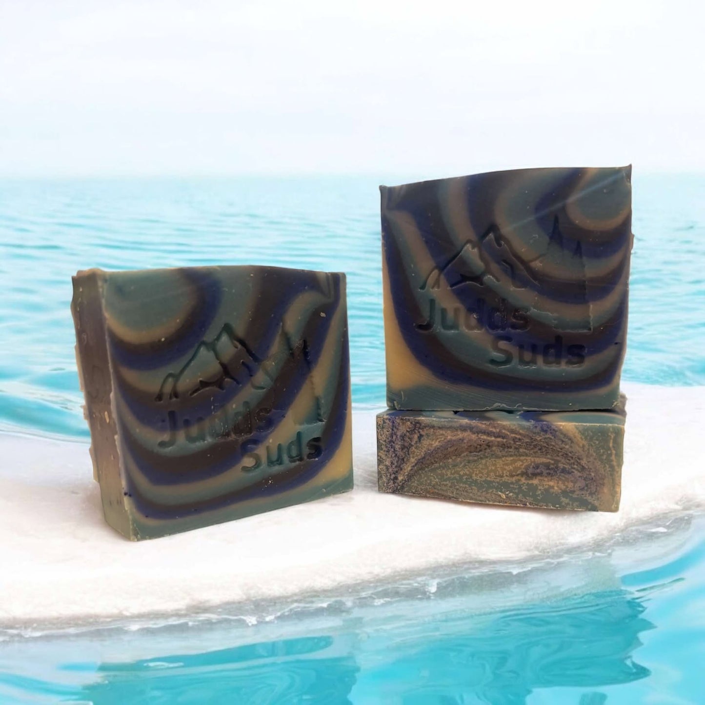 4oz bar soap, colored in multiple shades of blue and white. Scented with aqua di gio fragrance oil.