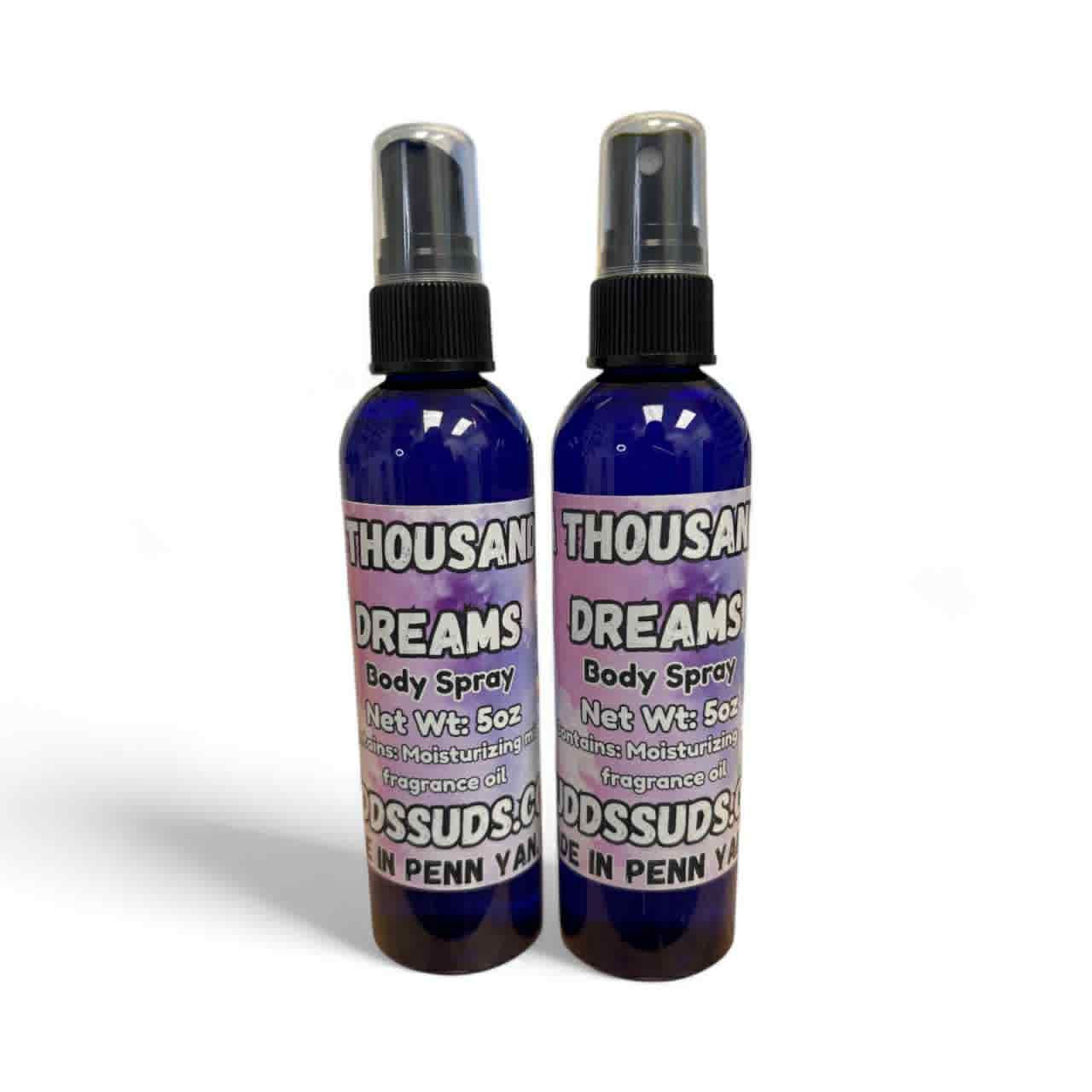 Two bottles of Thousand Dreams body spray on a white background