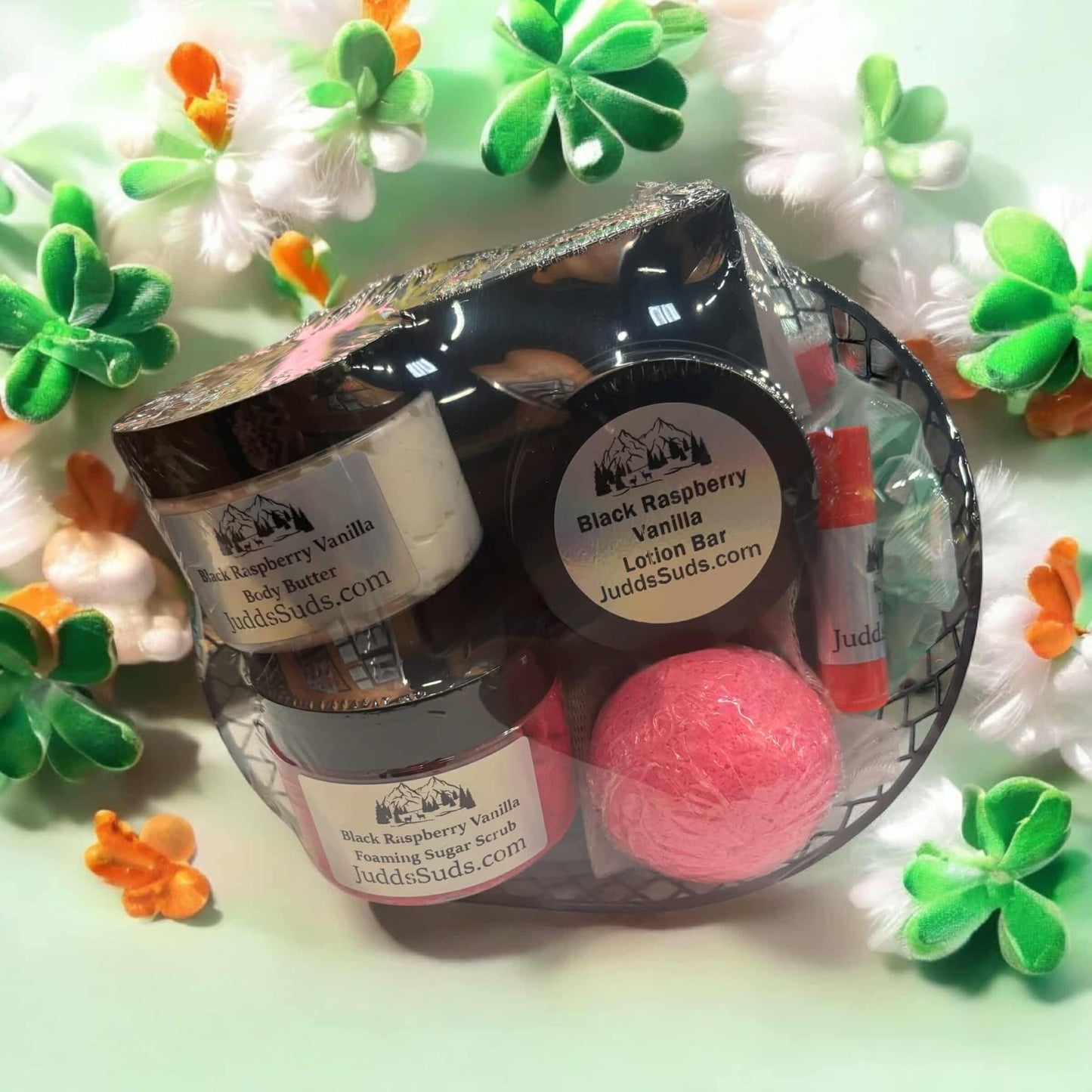 Gift basket containing soap bar, lotion bar, soap bag, lip balm, body butter, bath bomb and foaming sugar scrub. Scented in black raspberry vanilla