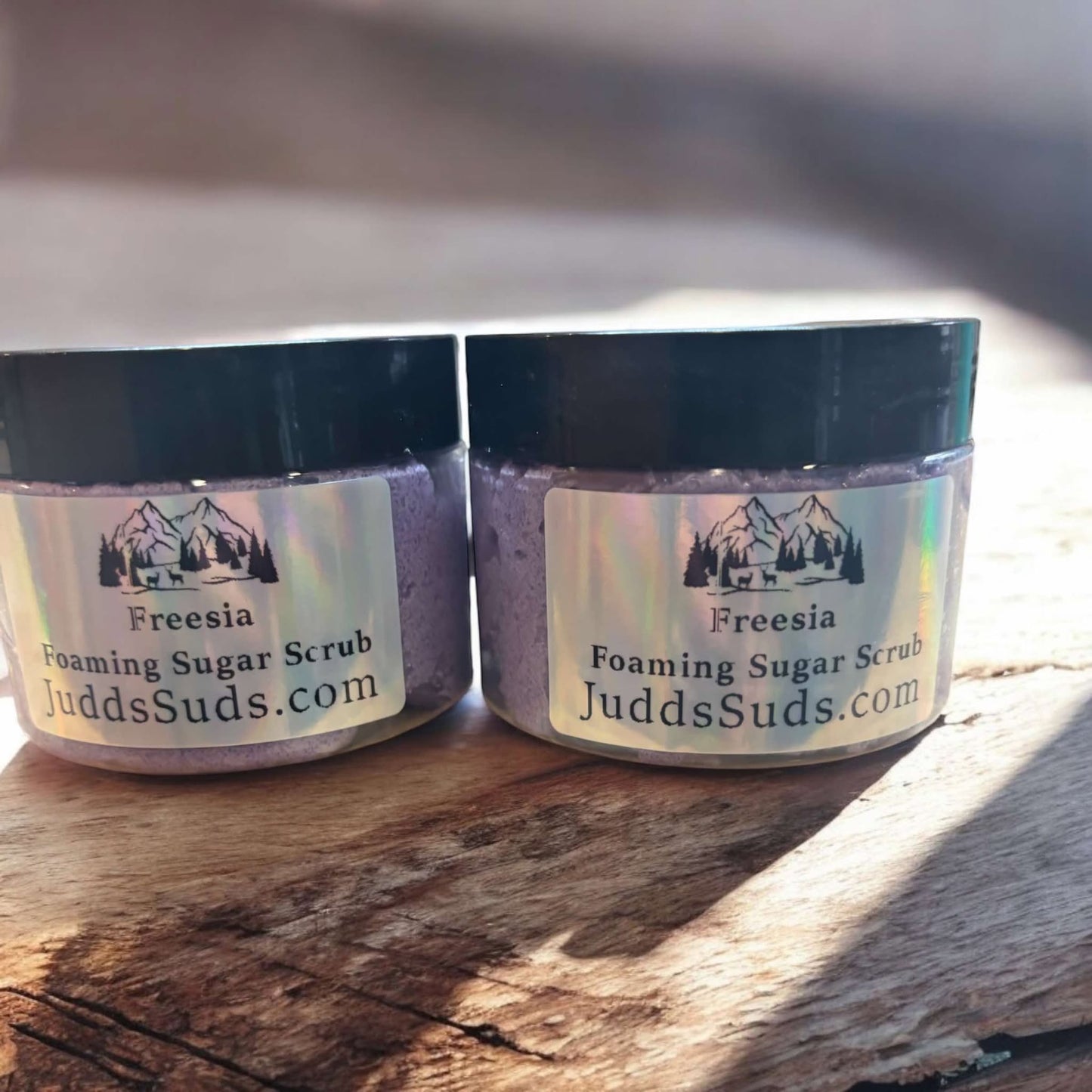 4oz jar of foaming sugar scrub, colored purple, scented with Freesia foaming sugar scrub.