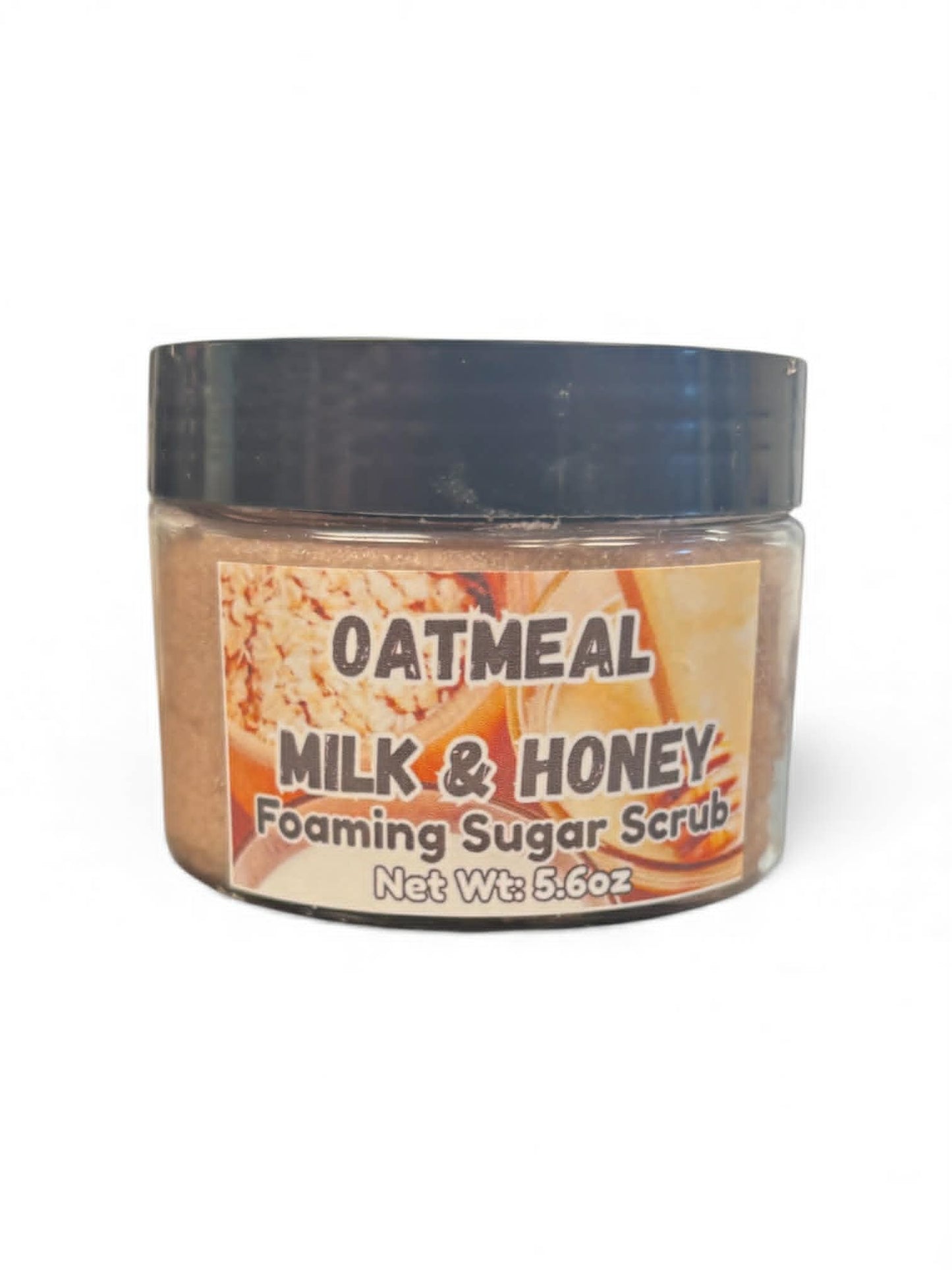 Jar of oatmeal milk and honey foaming sugar scrub with a black lid on a white background