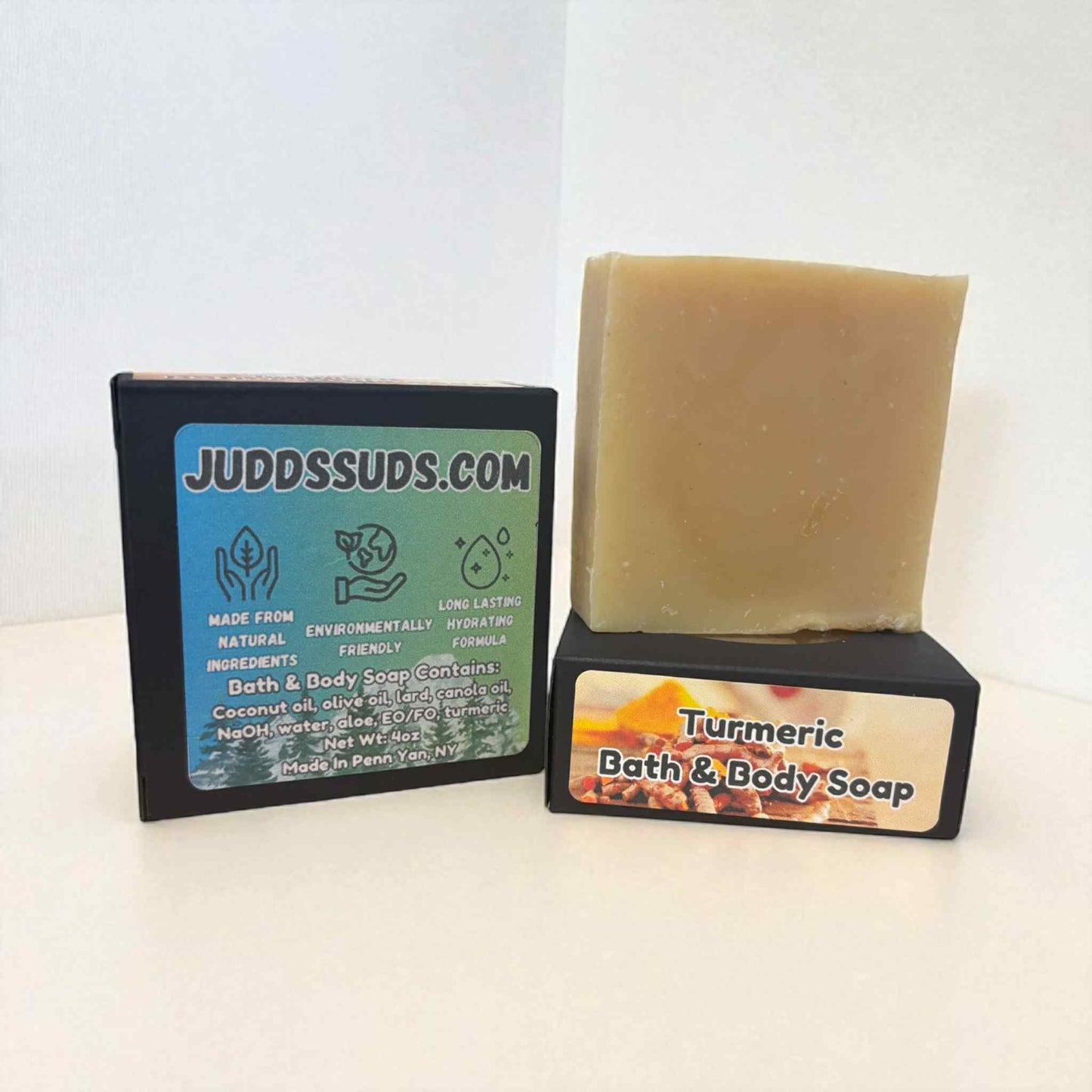Bar of turmeric bath and body soap on a stand with Judds Suds branding.