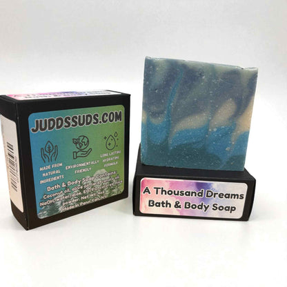 Bar of soap with packaging displaying 'JuddsSuds.com' and 'A Thousand Dreams Bath & Body Soap'.