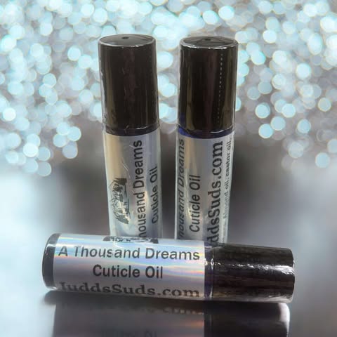 1.25 glass roller bottle, contains almond, avocado, castor oil, and vitamin E oil. Scented with A Thousand Dreams fragrance oil