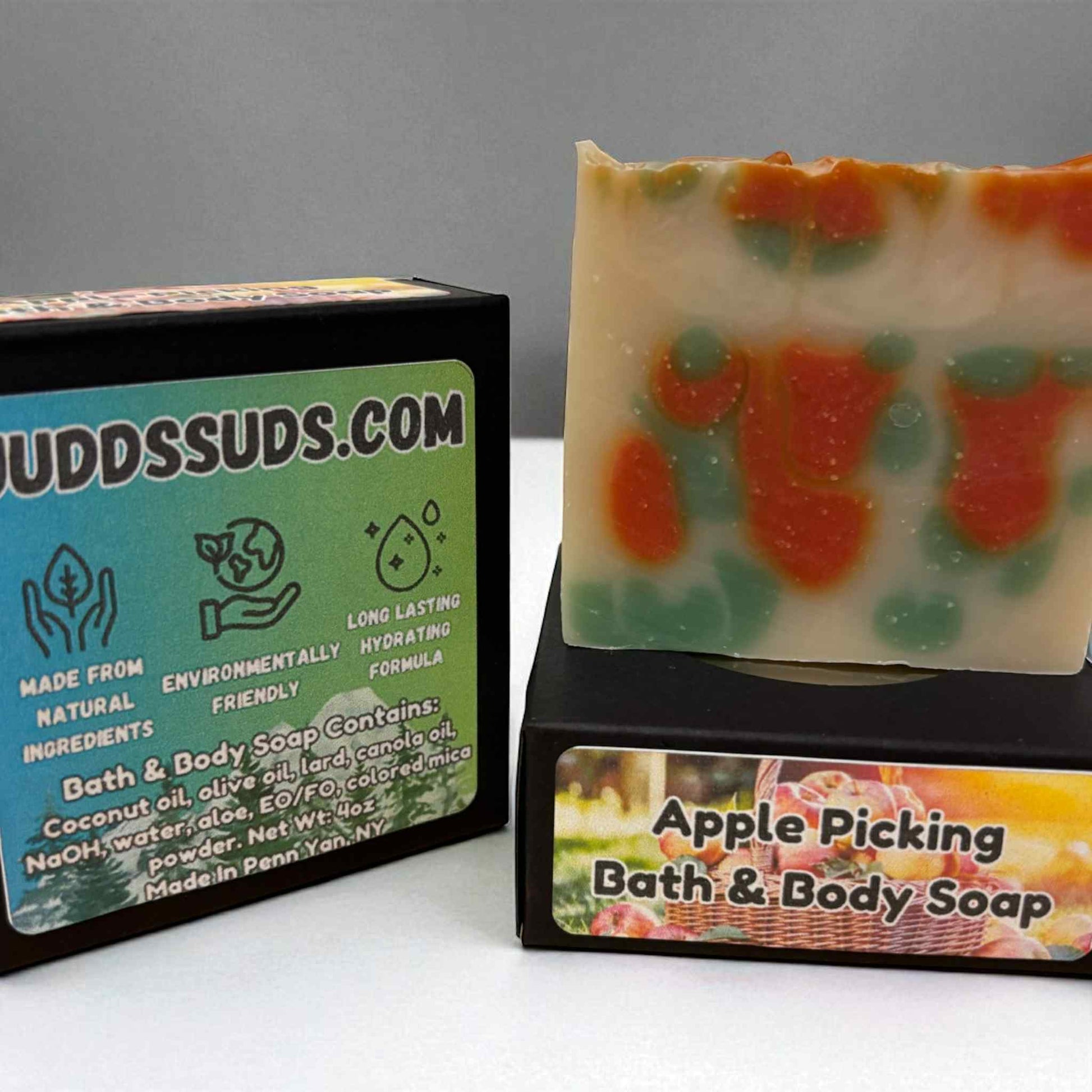 Soap with 'Apple Picking' design and packaging labeled 'Uuddsuds.com' on a gray background