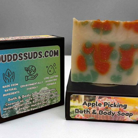 Soap with 'Apple Picking' design and packaging labeled 'Uuddsuds.com' on a gray background