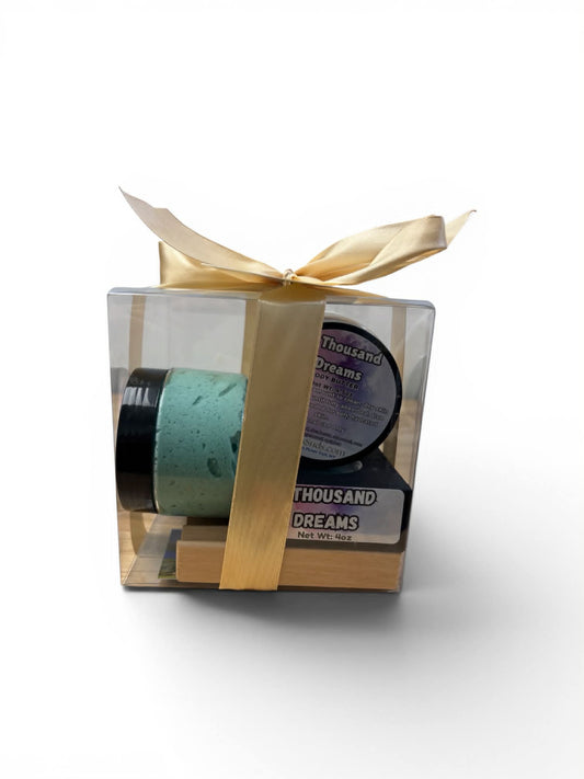 Gift set with a candle and packaging in a clear box with a gold ribbon on a white background
