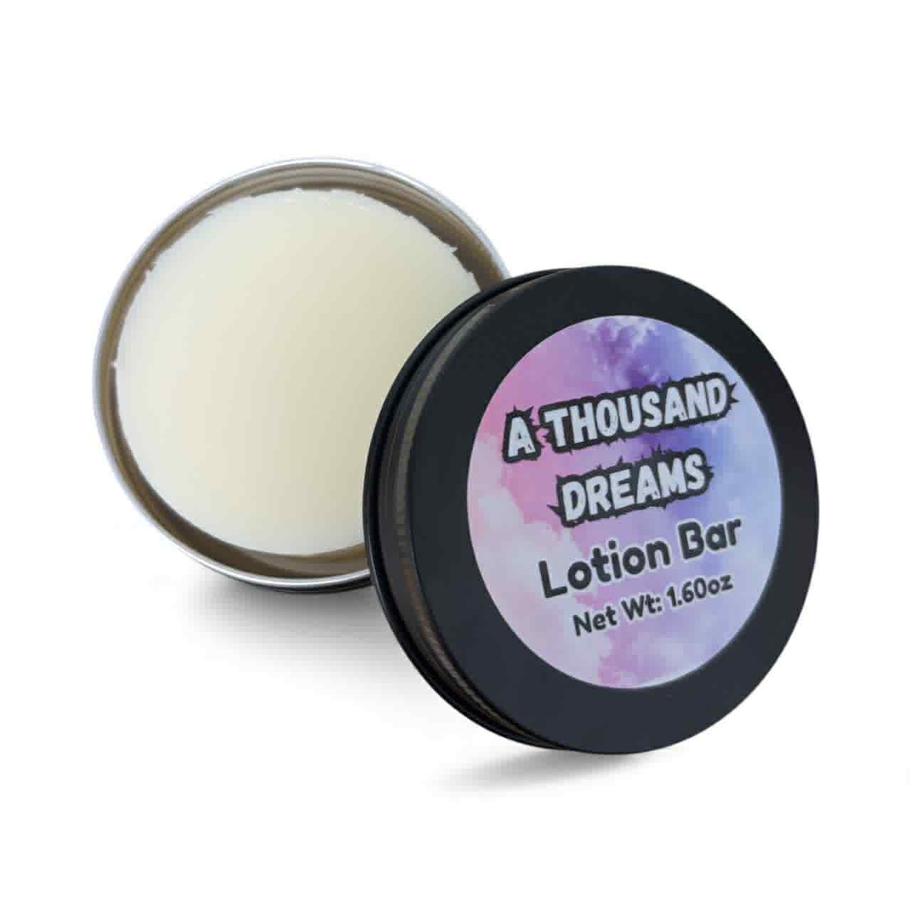 Lotion bar in a container with 'A Thousand Dreams' branding on a white background