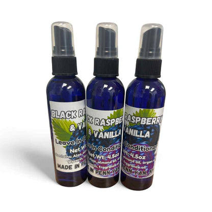 Three bottles of Black Raspberry Vanilla leave-in and conditioner on a white background