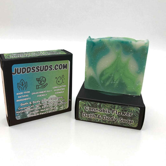 Green and white swirled soap bar with packaging on a white background