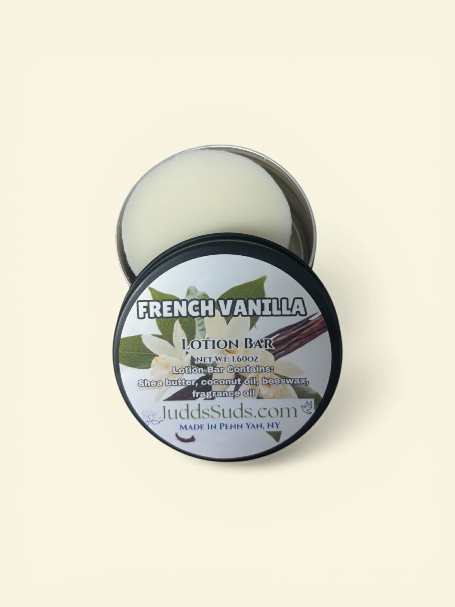 French Vanilla lotion bar in a tin with a label on a beige background