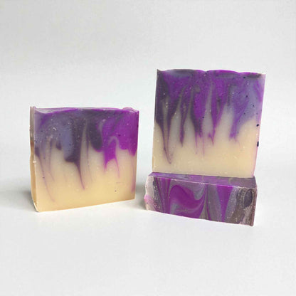Three bars of soap with purple and gray swirls on a white background