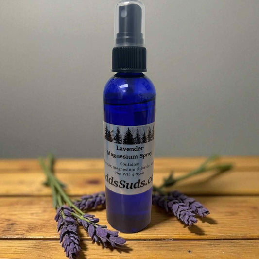 Blue spray bottle with lavender and label on a wooden surface