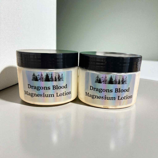 Two jars of Dragons Blood Magnesium Lotion on a light surface with a white background