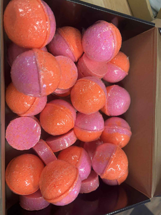 round bath bomb colored pink and orange, scented with Narcissist fragrance oil