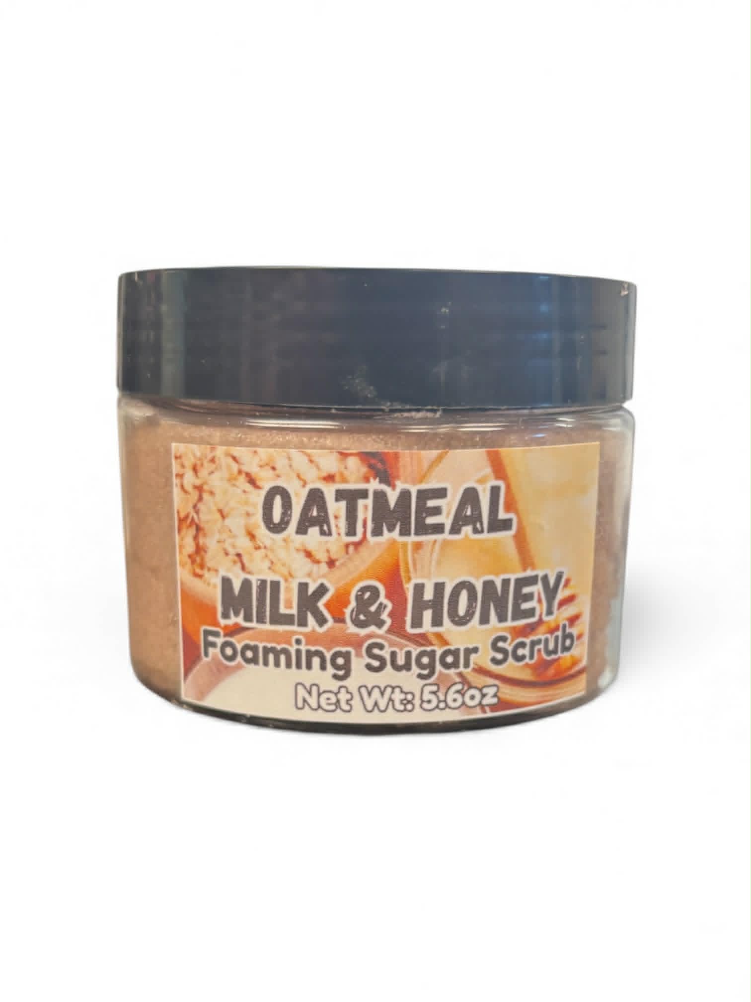 Jar of oatmeal milk and honey foaming sugar scrub with a black lid on a white background
