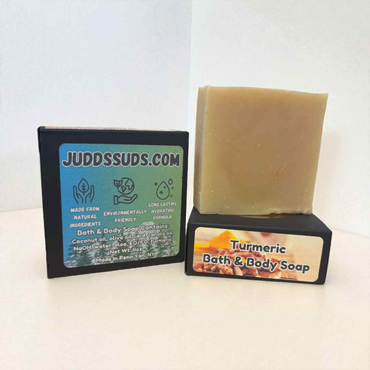 Bar of turmeric bath and body soap on a stand with Judds Suds branding.