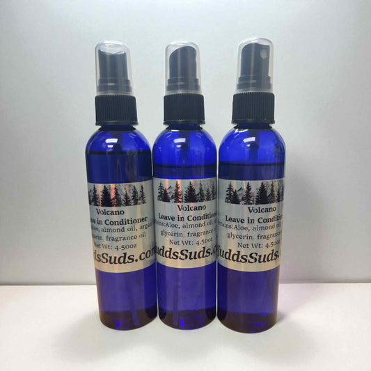 Three blue spray bottles with labels on a white background